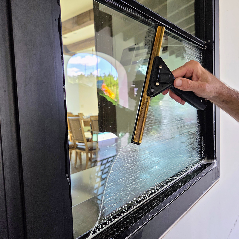 Professional window cleaning process in Austin, TX using hand-cleaned squeegee methods