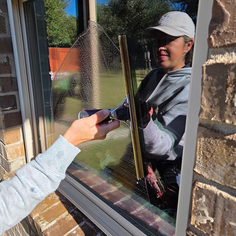 Professional window cleaning in Austin, TX with streak-free squeegee technique by C Clearly Window Cleaning
